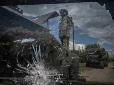 A Ukrainian serviceman repairs a military vehicle, amid Russia's attack on Ukraine, near the Russian border in Sumy region, Ukraine August 11, 2024. REUTERS/Viacheslav Ratynskyi