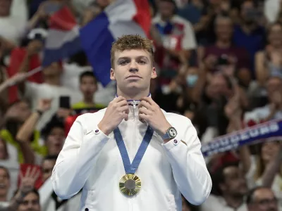 FILE - Leon Marchand of France, reacts after receiving his gold medal for the men's 200-meter individual medley final at the 2024 Summer Olympics, Friday, Aug. 2, 2024, in Nanterre, France. (AP Photo/Natacha Pisarenko, FIle)