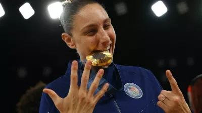 Paris 2024 Olympics - Basketball - Women's Victory Ceremony - Bercy Arena, Paris, France - August 11, 2024. Gold medallist Diana Taurasi of United States celebrates with her medal. REUTERS/Brian Snyder