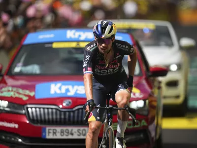 Slovenia's Primoz Roglic, who crashed in the final descent, crosses the finish line of the eleventh stage of the Tour de France cycling race over 211 kilometers (131.1 miles) with start in Evaux-les-Bains and finish in Le Lioran, France, Wednesday, July 10, 2024. (AP Photo/Daniel Cole)