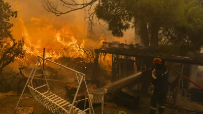 12 August 2024, Greece, Athens: A firefighter extinguishes a large fire, just a few kilometers northeast of Athens. EU member states are sending aid to Greece to help emergency services in battling the country's biggest wildfire of the year on Monday, with multiple flash points burning across some 200 square kilometres of woodland north-east of the capital Athens. Photo: Socrates Baltagiannis/dpa