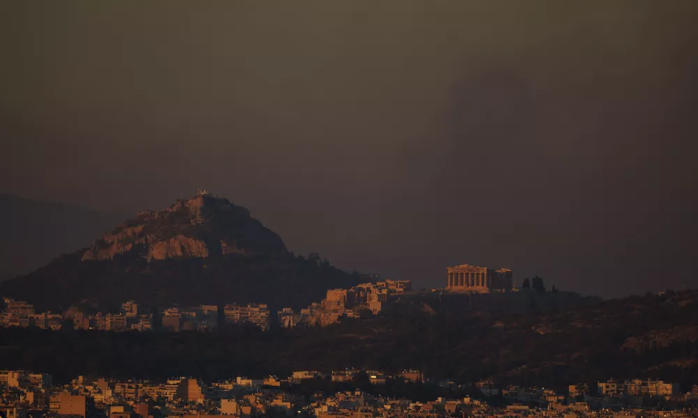 A general view of the of Athens with the Acropolis hill as fire burns the northern part of the city on Monday, Aug. 12, 2024, while hundreds of firefighters tackle a major wildfire raging out of control on fringes of Greek capital. (AP Photo/Petros Giannakouris)