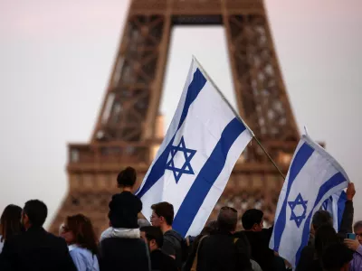 Israel supporters hold flags as they protest, following Hamas' biggest attack on Israel in years, in Paris, France, October 9, 2023. REUTERS/Benoit Tessier