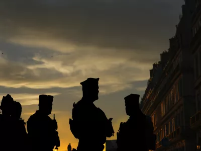 French police officers stand guard outside the Tuileries garden as the cauldron is extinguished on the final day of the 2024 Summer Olympics ahead of the closing ceremony, Sunday, Aug. 11, 2024, in Paris, France. (AP Photo/Dar Yasin)