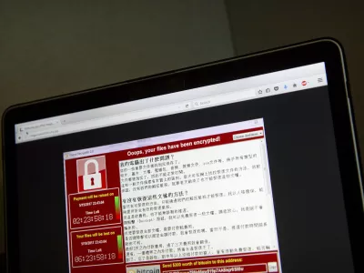 ﻿A screenshot of the warning screen from a purported ransomware attack, as captured by a computer user in Taiwan, is seen on laptop in Beijing, Saturday, May 13, 2017. Dozens of countries were hit with a huge cyberextortion attack Friday that locked up computers and held users' files for ransom at a multitude of hospitals, companies and government agencies. (AP Photo/Mark Schiefelbein)