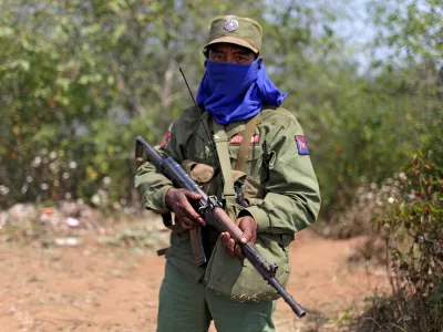 FILE PHOTO: A rebel soldier of the Myanmar National Democratic Alliance Army (MNDAA) holds his rifle as he guards near a military base in Kokang region March 11, 2015. Fighting broke out last month between Myanmar's army and MNDAA, which groups remnants of the Communist Party of Burma, a powerful Chinese-backed guerrilla force that battled Myanmar's government before splintering in 1989. Picture taken March 11, 2015. REUTERS/Stringer (MYANMAR - Tags: MILITARY POLITICS CIVIL UNREST) CHINA OUT. NO COMMERCIAL OR EDITORIAL SALES IN CHINA/File Photo