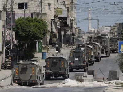 A column of Israeli Army armored vehicles leave following a military operation in the West Bank town of Tubas, Wednesday, Aug. 14, 2024. (AP Photo/Majdi Mohammed)