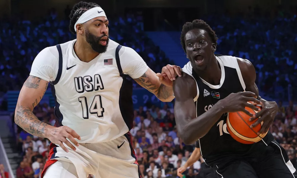 Paris 2024 Olympics - Basketball - Men's Group Phase - Group C - United States vs South Sudan - Lille, Pierre Mauroy Stadium, Villeneve-d'Ascq, France - July 31, 2024. Anthony Davis of United States in action with Jt Thor of South Sudan REUTERS/Brian Snyder