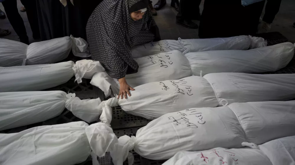 FILE - Palestinians mourn their relatives killed in the Israeli bombardment of the Gaza Strip, outside a morgue in Rafah, southern Gaza, Wednesday, Jan. 10, 2024. (AP Photo/Fatima Shbair, File)