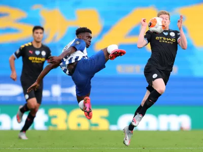 ﻿11 July 2020, England, Brighton: Brighton and Hove Albion's Yves Bissouma (L) challenges Manchester City's Kevin De Bruyne during the English Premier League soccer match between Brighton & Hove Albion and Manchester City at the Amex Stadium. Photo: Catherine Ivill/Nmc Pool/PA Wire/dpa