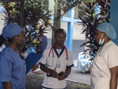 Medical staff talk to each other at the general hospital in Goma, Democratic Republic Of Congo, Wednesday, Aug. 14, 2024 after the World Health Organization declared the mpox outbreaks in Congo and elsewhere in Africa a global emergency. (AP Photo/Moses Sawasawa)