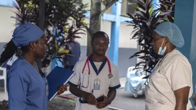 Medical staff talk to each other at the general hospital in Goma, Democratic Republic Of Congo, Wednesday, Aug. 14, 2024 after the World Health Organization declared the mpox outbreaks in Congo and elsewhere in Africa a global emergency. (AP Photo/Moses Sawasawa)