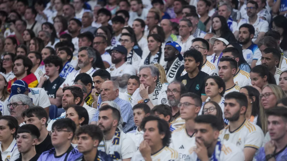 Real Madrid fans watch on screens at Santiago Bernabeu stadium the Champions League final soccer match between Real Madrid and Borussia Dortmund, in Madrid, Spain, Saturday, June 1, 2024. (AP Photo/Paul White)