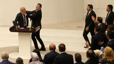 Turkey's AK Party lawmaker Alpay Ozalan scuffles with Workers' Party of Turkey (TIP) lawmaker Ahmet Sik, who was speaking during an extraordinary meeting of the Turkish parliament to discuss jailed opposition lawmaker Can Atalay's return to the assembly, in Ankara, Turkey August 16, 2024. REUTERS/Cagla Gurdogan   TPX IMAGES OF THE DAY