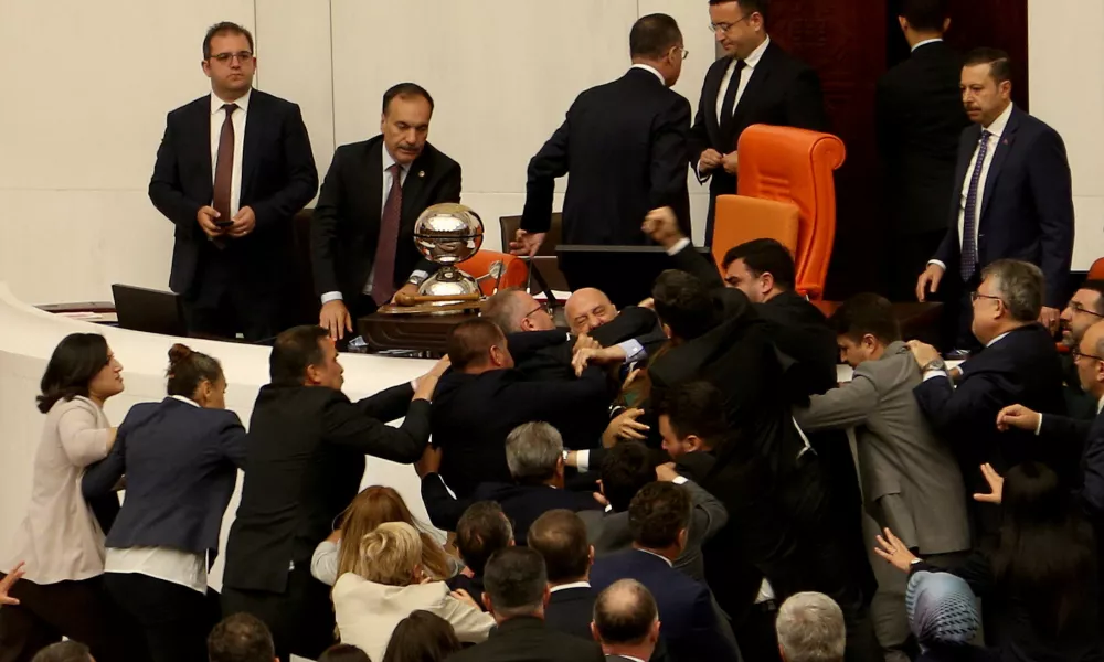 Workers' Party of Turkey (TIP) lawmaker Ahmet Sik scuffles with lawmakers from the ruling AK Party (AKP) during an extraordinary meeting of the Turkish parliament to discuss jailed opposition lawmaker Can Atalay's return to the assembly, in Ankara, Turkey August 16, 2024. REUTERS/Cagla Gurdogan