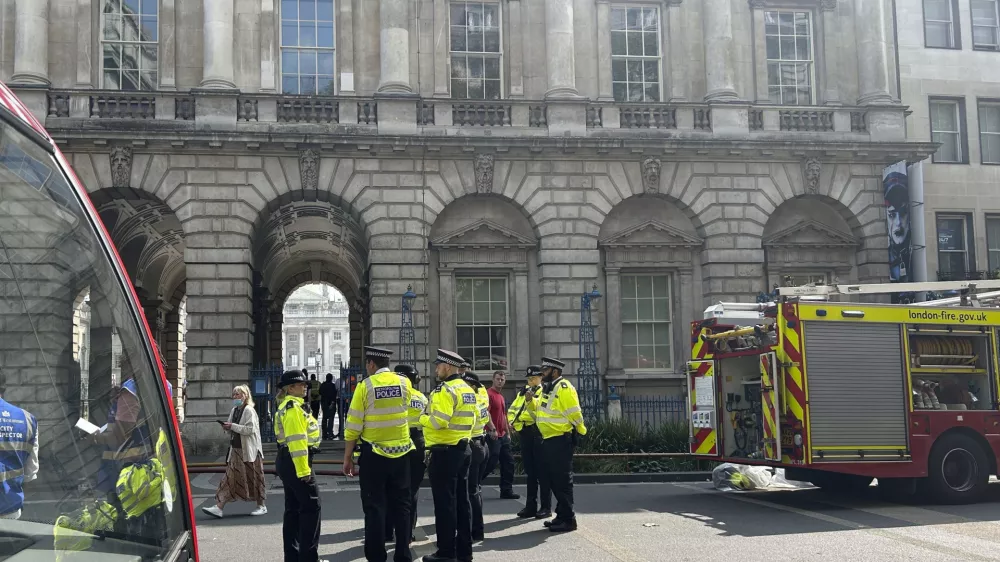 Emergency services outside Somerset House in central London. Saturday Aug. 17, 2024, after a fire broke out the large neoclassical arts venue. (Pol Allingham/PA via AP)