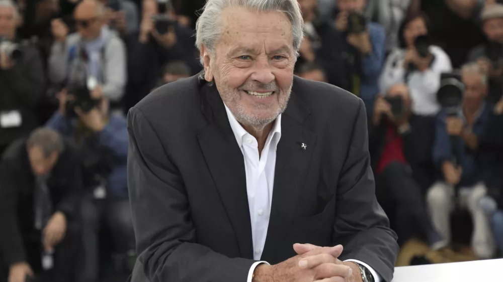 FILE - Actor Alain Delon poses for photographers at the photo call for his honorary Palme D'Or award at the 72nd international film festival, Cannes, southern France, Sunday, May 19, 2019. Alain Delon, the internationally acclaimed French actor who embodied both the bad guy and the policeman and made hearts throb around the world, has died at age 88, French media reported. (Photo by Vianney Le Caer/Invision/AP)