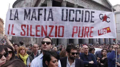 People gather during a demonstration of solidarity in front of Rome's Pantheon for the victims of the explosive device that went off near the "Francesca Morvillo Falcone" high school in Brindisi, Italy, Saturday, May 19, 2012. An explosive device went off outside a high school in southern Italy named after a slain anti-Mafia prosecutor as students arrived for class Saturday, killing one of them and wounding seven others, officials said. The device went off just before 8 a.m. in the Adriatic port town of Brindisi just as students milled outside, chatting and getting ready for class at the vocational institute named after the slain anti-Mafia prosecutor Giovanni Falcone and his wife. The banner reads: "Mafia kills, silence as well (kills)". (AP Photo/Roberto Monaldo, Lapresse) ITALY OUT