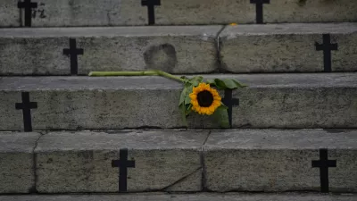 Sunflowers and crosses cover the City Council steps during a protest against femicide on International Women's Day in Rio de Janeiro, Brazil, Friday, March 8, 2024. (AP Photo/Silvia Izquierdo)