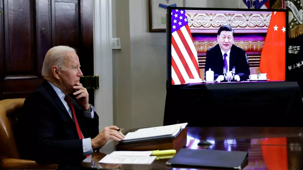 FILE PHOTO: U.S. President Joe Biden speaks virtually with Chinese leader Xi Jinping from the White House in Washington, U.S. November 15, 2021. REUTERS/Jonathan Ernst/File Photo