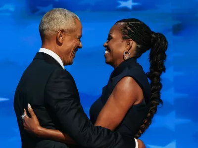 Former U.S. first lady Michelle Obama embraces her husband, former U.S. President Barack Obama, on stage before his speech during Day 2 of the Democratic National Convention (DNC) in Chicago, Illinois, U.S., August 20, 2024. REUTERS/Alyssa Pointer