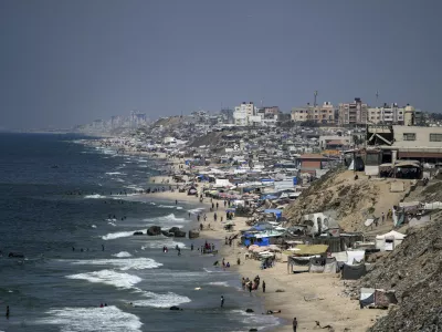 Tents are crammed together as displaced Palestinians camp on the beach, west of Deir al-Balah, Gaza Strip, Tuesday, Aug. 20, 2024. (AP Photo/Abdel Kareem Hana)