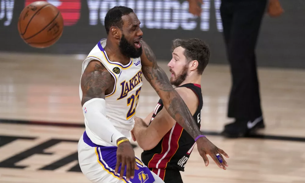 ﻿Los Angeles Lakers' LeBron James (23) collides with Miami Heat's Goran Dragic (7) during the first half in Game 6 of basketball's NBA Finals Sunday, Oct. 11, 2020, in Lake Buena Vista, Fla. (AP Photo/Mark J. Terrill)