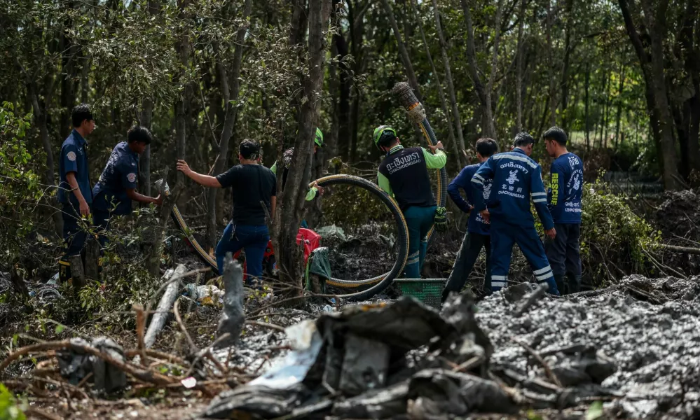 Rescue workers search the wreckage of a small aircraft a day after it crashed as five tourists from China and four Thais, including the two pilots, all presumed dead, in Bang Pakong, Chachoengsao province, Thailand, August 23, 2024. REUTERS/Patipat Janthong