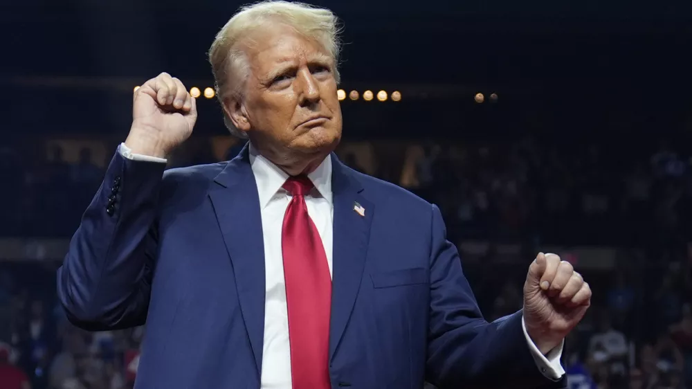 Republican presidential nominee former President Donald Trump dances at a campaign rally at the Desert Diamond Arena, Friday, Aug. 23, 2024, in Glendale, Ariz. (AP Photo/Evan Vucci)