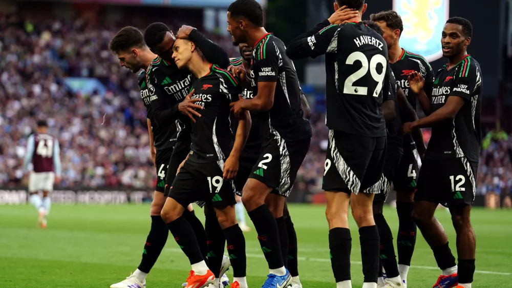 24 August 2024, United Kingdom, Birmingham: Arsenal's Leandro Trossard (3rd L) celebrates scoring his side's first goal with teammates during the English Premier League soccer match between Aston Villa and Arsenal at Villa Park. Photo: David Davies/PA Wire/dpa