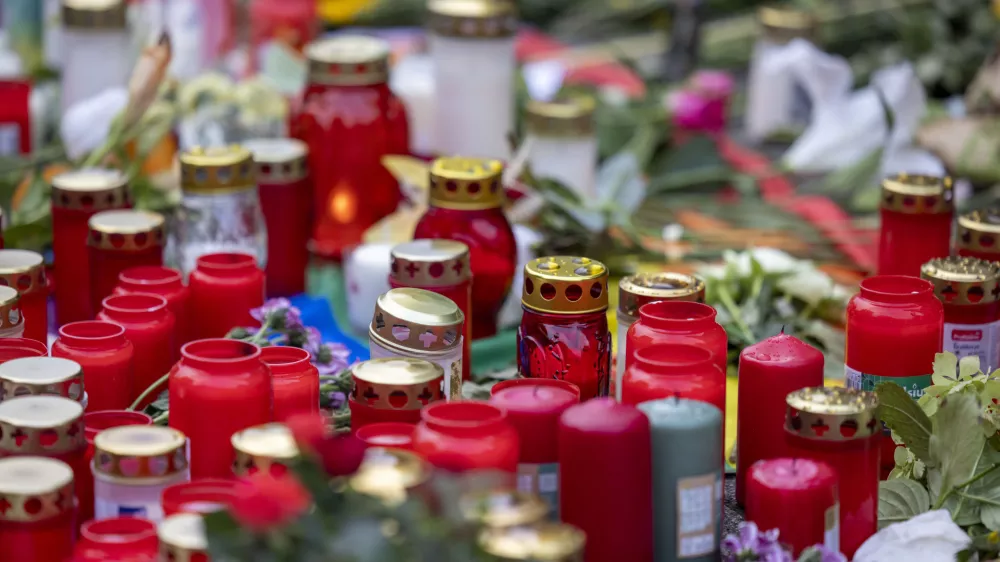 Flowers and candles are placed Sunday, Aug. 25, 2024, near the scene of Friday's deadly attack at the city's 650th anniversary celebrations in the city center of Solingen, Germany. (Thomas Banneyer/dpa via AP)