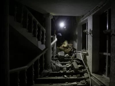 A man walks on stairs among debris inside a hotel hit by a Russian missile strike, amid Russia's attack on Ukraine, in Kramatorsk, Donetsk region, Ukraine August 24, 2024. REUTERS/Thomas Peter