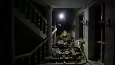 A man walks on stairs among debris inside a hotel hit by a Russian missile strike, amid Russia's attack on Ukraine, in Kramatorsk, Donetsk region, Ukraine August 24, 2024. REUTERS/Thomas Peter