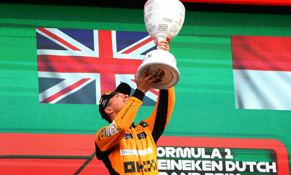 Formula One F1 - Dutch Grand Prix - Circuit Zandvoort, Zandvoort, Netherlands - August 25, 2024 McLaren's Lando Norris celebrates with a trophy on the podium after winning the Dutch Grand Prix REUTERS/Lisi Niesner