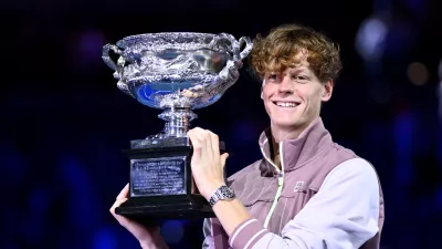 Jannik Sinner of Italy poses for photographs with the Norman Brookes Challenge Cup following his win in the Men's Singles final against Daniil Medvedev of Russia on Rod Laver Arena on Day 15 of the 2024 Australian Open at Melbourne Park in Melbourne, Sunday, January 28, 2024. (AAP Image/Joel Carrett) NO ARCHIVING, EDITORIAL USE ONLY