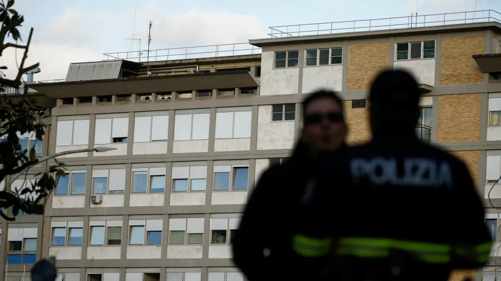 Police officers stand outside Gemelli Hospital where Pope Francis attends a previously scheduled check-up, in Rome, Italy March 29, 2023. REUTERS/Guglielmo Mangiapane