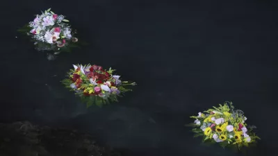 Flowers were sent out to sea as a tribute as Don Vincenzo the parish priest of Porticello in the municipality of Santa Flavia, celebrated mass for the victims of the Bayesian shipwreck in Porticello, Italy, Sunday, Aug. 25, 2024. (Alberto Lo Bianco/LaPresse via AP)