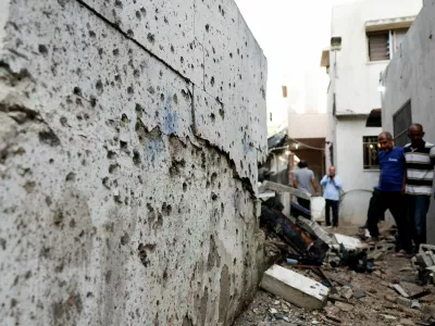 Palestinians assess damage at the site of a drone strike in Nur Shams refugee camp in Tulkarm in the Israeli-occupied West Bank, August 27, 2024. REUTERS/Mohammed Torokman