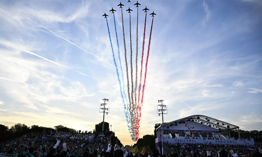 The Patrouille de France fly over the Place de la Concorde during the Paris 2024 Paralympic Games Opening Ceremony in Paris, France, Wednesday Aug. 28, 2024. (Julien De Rosa/Pool Photo via AP)