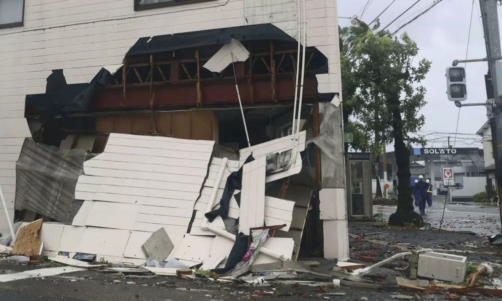 An exterior wall of a building is seen damaged by strong wind of a typhoon in Miyazaki, western Japan, Thursday, Aug. 29, 2024. (Kyodo News via AP)