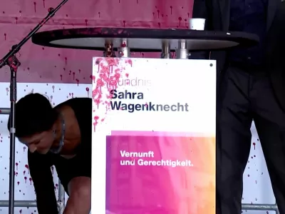 Sahra Wagenknecht, top candidate of Germany's Sahra Wagenknecht Alliance (BSW) party in the Thuringia state elections, takes cover after paint was thrown at the podium where she spoke during an election campaign rally in Erfurt, Germany, August 29, 2024, in this still image obtained from a video. Reuters TV via REUTERS