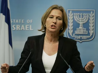 Israeli Foreign Minister Tzipi Livni gestures as she answers a reporter's question during a joint news conference with Germany's Foreign Minister Frank-Walter Steinmeier, not seen, following their meeting in Jerusalem, Sunday Jan. 11, 2009. Steinmeier was set to hold talks with Israeli leaders Sunday in Egypt in an attempt to advance the Security Council's cease-fire call. 'Israel must be persuaded to let the firearms rest now,' Steinmeier told reporters Sunday. (AP Photo/Lefteris Pitarakis)