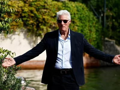 Actor Richard Gere gestures as he arrives during the 81st Venice Film Festival, in Venice, Italy, September 1, 2024. REUTERS/Yara Nardi