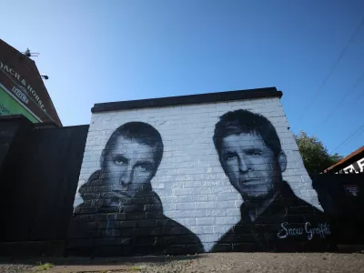 A mural of Oasis band members Liam and Noel Gallagher by artist Snow Graffiti is seen on the wall of the Coach and Horses pub in Whitefield, near Manchester, Britain, August 31, 2024. REUTERS/Phil Noble