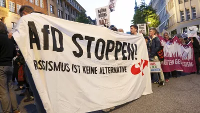 Participants in a demonstration against the right hold a banner with the slogan "Stop AfD! Racism is not an alternative" in Hamburg, Sunday, Sept. 1, 2024. (Bodo Marks/dpa via AP)