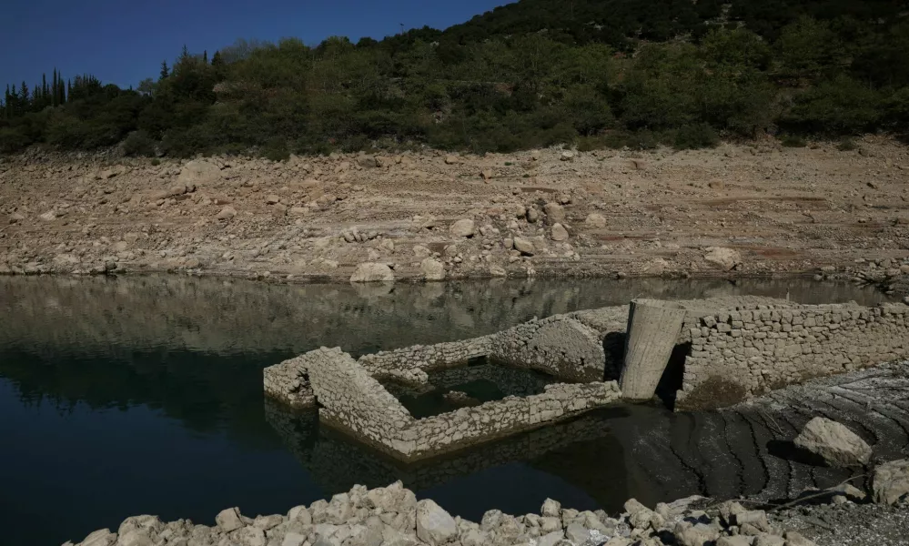 The reappearing remains of a building of the village of Kallio, which was intentionally flooded in 1980 to create a reservoir that would help meet the water needs of Greek capital Athens, are seen following receding water levels caused by drought, in Lake Mornos, Greece, September 3, 2024. REUTERS/Stelios Misinas