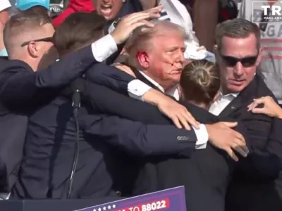 BUTLER, PENNSYLVANIA, UNITED STATES - JULY 13: (----EDITORIAL USE ONLY - MANDATORY CREDIT - 'TRUMP CAMPAIGN OFFICE / HANDOUT' - NO MARKETING NO ADVERTISING CAMPAIGNS - DISTRIBUTED AS A SERVICE TO CLIENTS----) A screen grab captured from a video shows Republican presidential candidate former President Donald Trump appears to be injured after gunshots were reported as he is rushed offstage during a rally on July 13, 2024 in Butler, Pennsylvania. Trump was seen bloodied on his right ear as he was being evacuated from the stage, according to social media footage. (Photo by Trump Campaign Office / Handout/Anadolu via Getty Images)