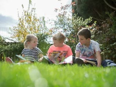 children reading in the garden