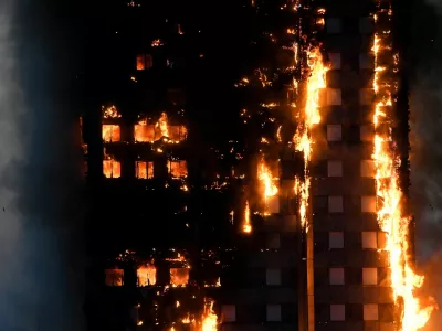 FILE PHOTO: The Grenfell Tower residential building is seen on fire in London, Britain, June 14, 2017. REUTERS/Toby Melville/File Photo