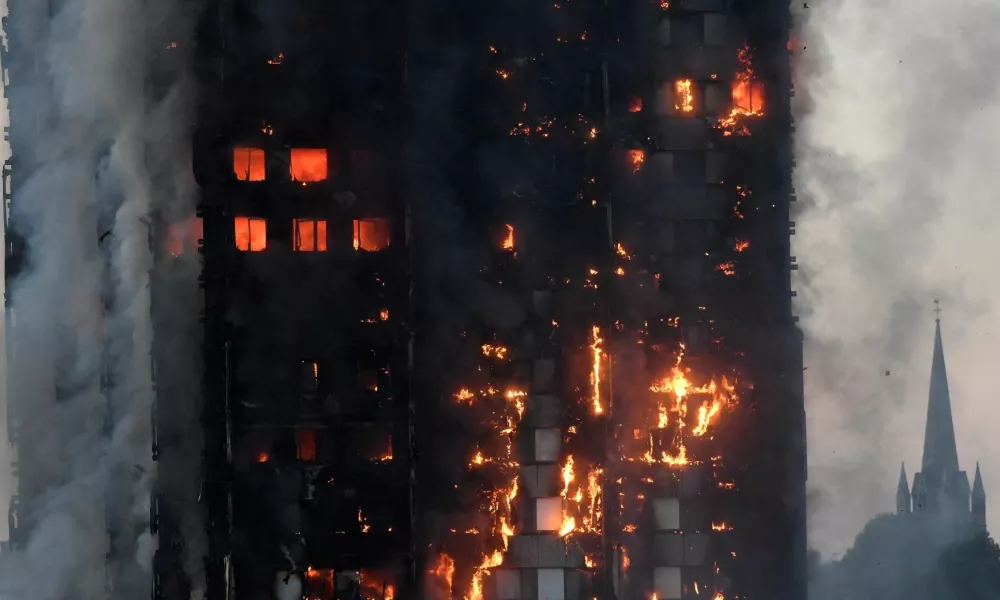 FILE PHOTO: The Grenfell Tower residential building is seen on fire in London, Britain, June 14, 2017. REUTERS/Toby Melville/File Photo